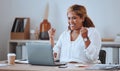 Happy and cheerful mixed race business woman cheering while working on a laptop in office. Confident hispanic female Royalty Free Stock Photo