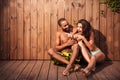 Happy cheerful mixed race couple showing pointing fingers away