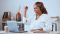 Happy and cheerful mixed race female call center agent cheering in support and working on a laptop in an office at work Royalty Free Stock Photo