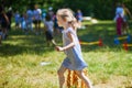 Happy cheerful preschool girl walking in park