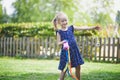 Happy cheerful preschool girl walking in park