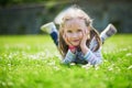 Happy cheerful preschool girl walking in park