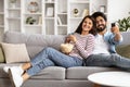 Happy young indian couple watching TV together at home Royalty Free Stock Photo