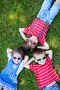 Happy cheerful smiling children, laying on a grass, wearing sung Royalty Free Stock Photo