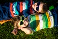 Happy cheerful smiling children, laying on a grass, wearing sung Royalty Free Stock Photo