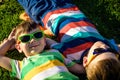 Happy cheerful smiling children, laying on a grass, wearing sung Royalty Free Stock Photo