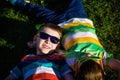 Happy cheerful smiling children, laying on a grass, wearing sung Royalty Free Stock Photo