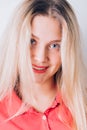 Happy cheerful young woman with clean skin, natural makeup wearing red dress Royalty Free Stock Photo