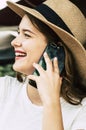 Happy cheerful young woman talking at the phone in cellular call with friends. Outdoor beauty girl using smartphone to talk with Royalty Free Stock Photo
