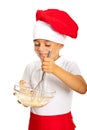 Happy chef boy mixing dough Royalty Free Stock Photo