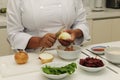 Happy chef cutting onions Royalty Free Stock Photo