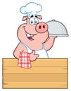 Happy Chef Pig Cartoon Mascot Character With A Cloche Platter Over A Wooden Sign Giving A Thumb Up Royalty Free Stock Photo