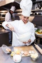 Happy chef whisking bowl of eggs Royalty Free Stock Photo