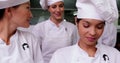 Happy chef whisking egg in a bowl