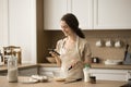 Happy chef woman using smartphone over table with bakery fo Royalty Free Stock Photo