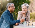 Happy, chess or couple of friends in nature playing a board game, bonding or talking about a funny story. Park, support