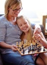 Happy, chess and a mother and child with a game for competition, strategy or thinking. Smile, family and a mom, girl or