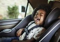 Happy child in a baby car seat Royalty Free Stock Photo