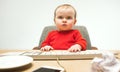 Happy child baby girl toddler sitting with keyboard of computer isolated on a white background Royalty Free Stock Photo