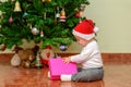 Happy child baby toddler kid with a Christmas gift. Royalty Free Stock Photo