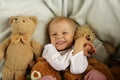 Happy child in bed with teddy bear