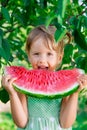 Happy child with big watermelon slice. Little girl eating fruit. Close up. Portrait. . Royalty Free Stock Photo