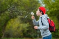 Happy child blowing dandelion flower outdoors. Boy having fun in spring park. Blurred green background Royalty Free Stock Photo