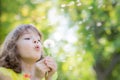 Happy child blowing dandelion flower outdoors Royalty Free Stock Photo