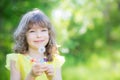 Happy child blowing dandelion flower outdoors Royalty Free Stock Photo