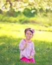 Happy child blowing dandelion outdoors in spring Royalty Free Stock Photo