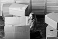 happy child box. repair of room. new apartment. unpacking moving boxes. happy little girl sit in room on boxes Royalty Free Stock Photo