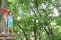 Happy child boy in adventure park in safety equipment Royalty Free Stock Photo