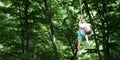 Happy child boy in adventure park in safety equipment Royalty Free Stock Photo