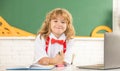 happy child boy in bow tie study in school classrrom at blackboard, back to school Royalty Free Stock Photo