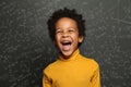 Happy child boy on chalkboard background with science formulas