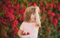 Happy child boy eat strawberry. Lovely funny child eating strawberries.