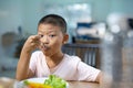 Happy child boy eating vegetables at home. Royalty Free Stock Photo