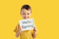 Happy child boy  holding a poster for your information on the blue background. Royalty Free Stock Photo