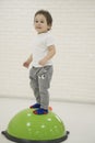 Happy child boy jumping on bouncing ball. Royalty Free Stock Photo