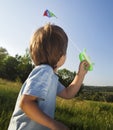 Happy child boy play with a kite running on summer meadow Royalty Free Stock Photo