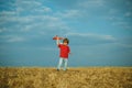 Happy child boy running on meadow with toy airplane in summer in nature. Happy childhood. Summer portrait of happy cute Royalty Free Stock Photo