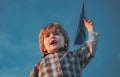 Happy child boy running on meadow with toy airplane in summer in nature. Little cute boy playing with a toy airplane Royalty Free Stock Photo