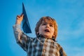 Happy child boy running on meadow with toy airplane in summer in nature. Little cute boy playing with a toy airplane Royalty Free Stock Photo