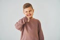 Happy child boy shows thumbs up and smiles on white background. Handsome kid posing and smiling. Royalty Free Stock Photo