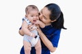 Happy child boy sucking fingers and looking at camera with a young woman kissing adorable baby boy isolated on white background Royalty Free Stock Photo