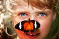 Happy child with butterfly on neck.