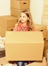 Happy child cardboard box. playing into new home. new apartment. happy little girl. Cardboard boxes - moving to new Royalty Free Stock Photo