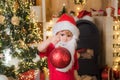 Happy child with Christmas ball. Cute little kids celebrating Christmas. Happy cute child in Santa hat with bauble have Royalty Free Stock Photo