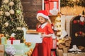 Happy child with Christmas gift. New year kids. New year concept. Child with a Christmas present on wooden house