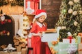 Happy child with Christmas gift. New year kids. New year concept. Child with a Christmas present on wooden house